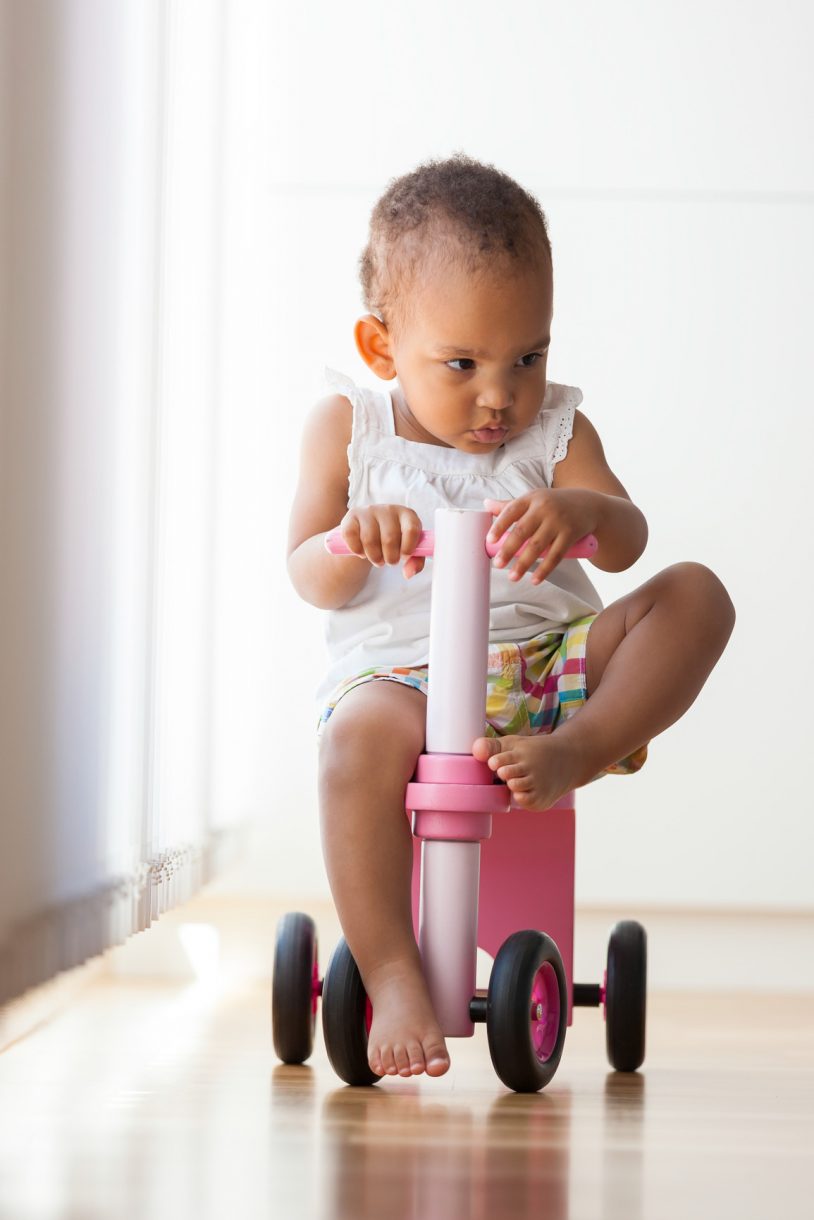 Portrait of little African American little girl riding a bike - ELC Foundation